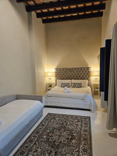 a bedroom with two beds and a rug at KASA San Francisco 1 in San Juan