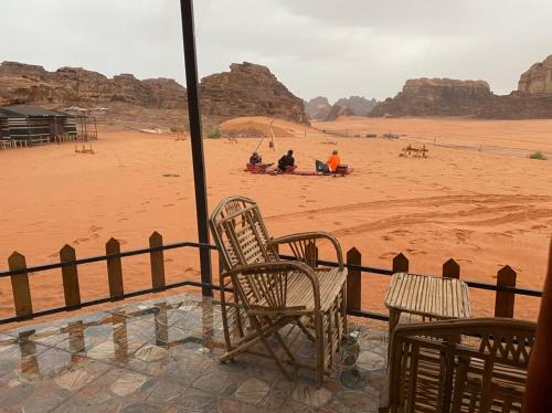 a group of people sitting in the desert at Desert Island Camp in Aqaba