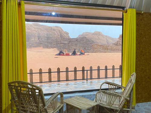 a room with chairs and a view of the desert at Desert Island Camp in Aqaba