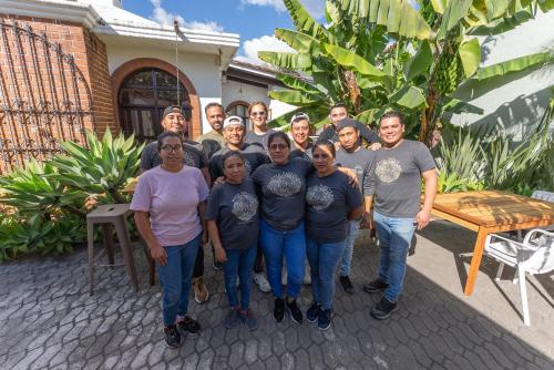 a group of people posing for a picture in front of a house at Maya Papaya in Antigua Guatemala