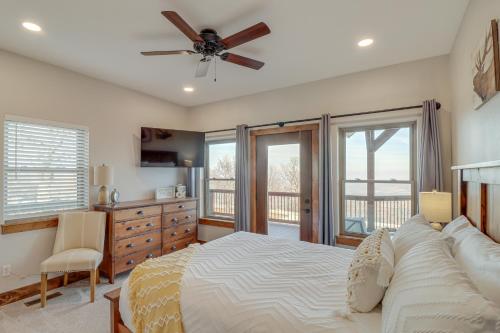 a bedroom with a bed and a ceiling fan at Spacious Harrison Vacation Rental with Deck and Views! in Harrison