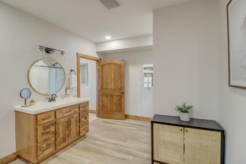 a bathroom with a sink and a mirror at Spacious Harrison Vacation Rental with Deck and Views! in Harrison