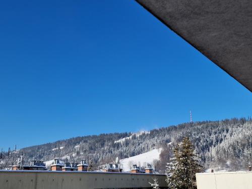 a view of a snowy mountain from a building at Łukaszówki przy Krupówkach in Zakopane