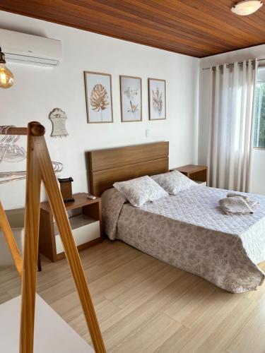 a bedroom with a bed with a wooden headboard at Karin’s Haus in Treze Tílias