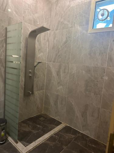 a shower with a faucet in a bathroom at أستديو فندقي ديلوكس in Jazan