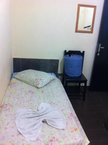 Un pat sau paturi într-o cameră la Cacique Hotel