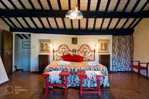 a bedroom with a bed and a table and chairs at Casa Dinda in Città di Castello