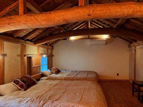 two beds in a room with a loft at The Bath & Bed Obuse - Vacation STAY 15924 in Obuse