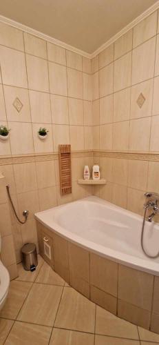 a bathroom with a tub and a toilet at Kasia house in Warsaw