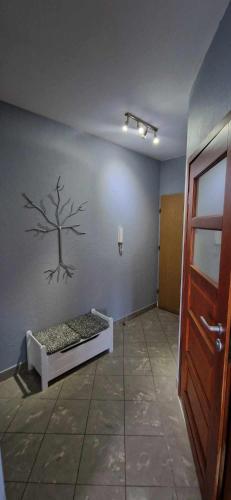 a room with a wall with a tree on the wall at Kasia house in Warsaw