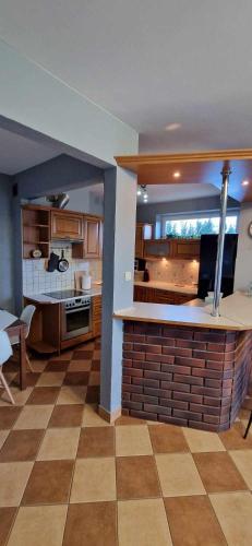 a living room with a kitchen with a counter top at Kasia house in Warsaw