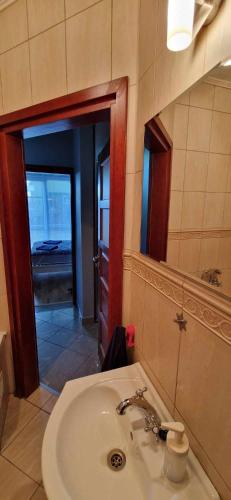 a bathroom with a sink and a mirror at Kasia house in Warsaw