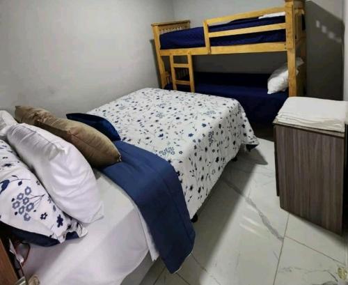 a bedroom with two beds and a bunk bed at Marhabibi's home in Sonsonate