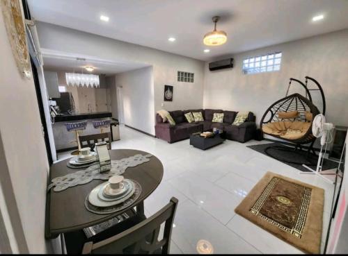 a living room with a table and a couch at Marhabibi's home in Sonsonate