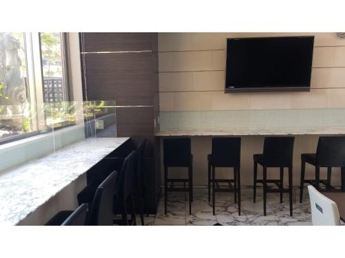a bar with chairs and a flat screen tv at My Hotel Okazaki - Vacation STAY 40799v in Okazaki