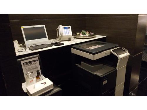 a office with a desk with a computer and a phone at My Hotel Okazaki - Vacation STAY 40799v in Okazaki