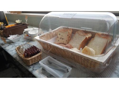 a plastic container filled with bread on top of a counter at My Hotel Okazaki - Vacation STAY 40801v in Okazaki