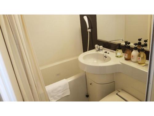 a bathroom with a sink and a toilet and a mirror at My Hotel Okazaki - Vacation STAY 40801v in Okazaki