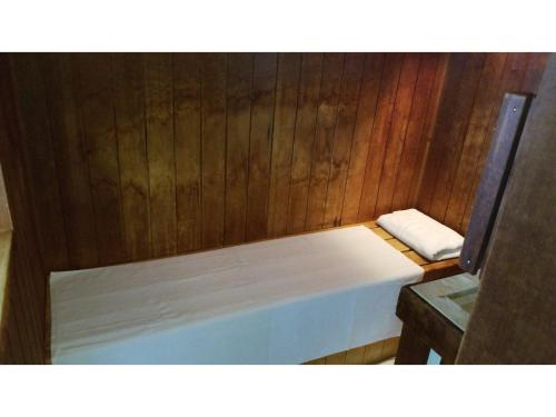 a small room with a bed in a wooden wall at My Hotel Okazaki - Vacation STAY 40801v in Okazaki