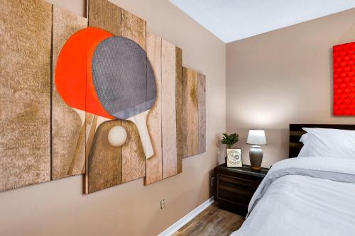 a bedroom with four paintings on the wall at Pong - A Birdy Vacation Rental in San Antonio