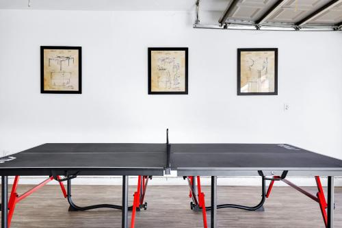 a ping pong table in front of a white wall at Pong - A Birdy Vacation Rental in San Antonio