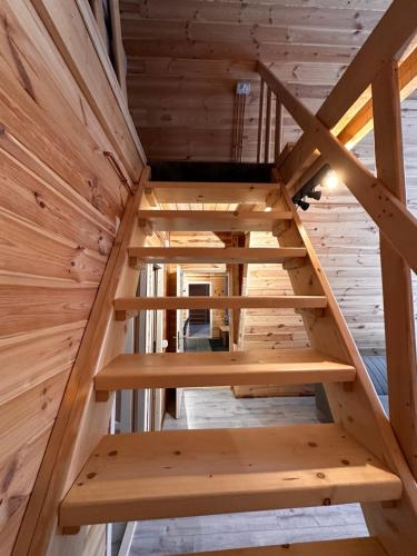 a staircase in a tiny house at CabanA Comandău in Comandău