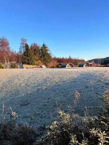 a large field with snow on the ground at Daviot Luxury Pods in Inverness