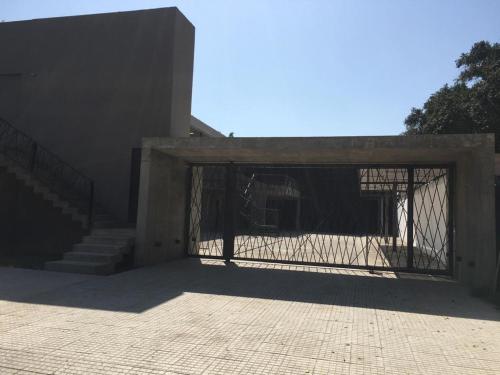 a gate to a building with stairs in it at Deparcasa in Yerba Buena