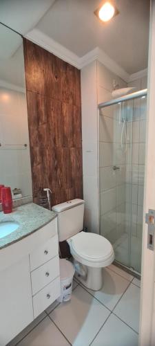 a bathroom with a toilet and a glass shower at 603 SEVILHA in Serra