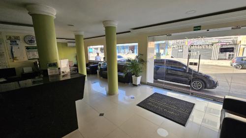 a lobby with a car parked outside of a car dealership at Hotel Barranquilla Inn in Barranquilla