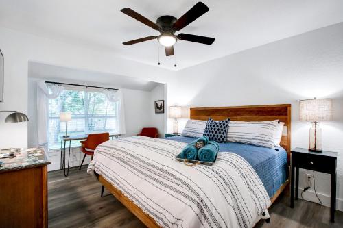 a bedroom with a large bed with a ceiling fan at Richters Retreat - A birdy Vacation Rental in Boerne