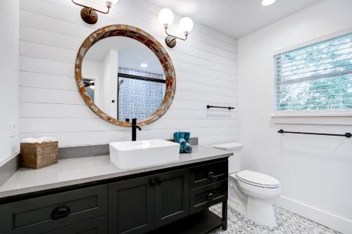 a bathroom with a sink and a mirror at Richters Retreat - A birdy Vacation Rental in Boerne