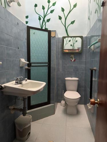a bathroom with a sink and a toilet at Hostal Casa Macondo in Santa Marta