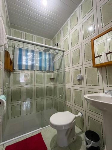 a bathroom with a toilet and a sink at Espaço caraguatá in Florianópolis