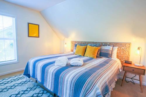 a bedroom with a large bed with towels on it at Heron Hideaway in Folly Beach