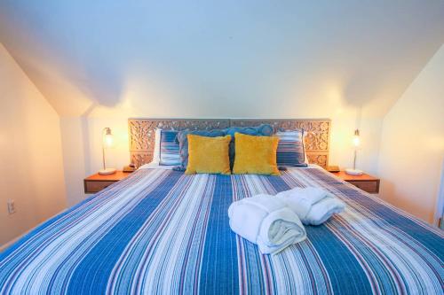 a bedroom with a bed with towels on it at Heron Hideaway in Folly Beach