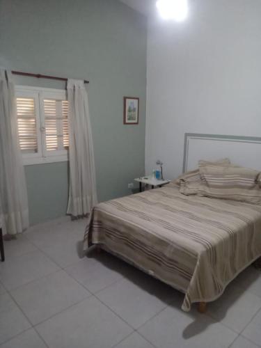 a bedroom with a large bed in a white room at DAS THOMY II in Córdoba