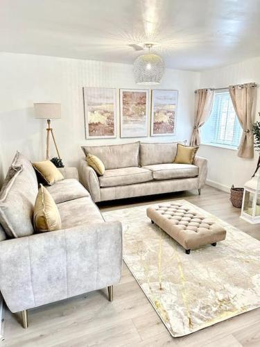a living room with two couches and a rug at Historic Charm: *Perfect For Group Getaways* in Trowbridge