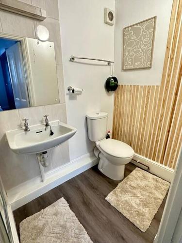 a bathroom with a toilet and a sink at Historic Charm: *Perfect For Group Getaways* in Trowbridge