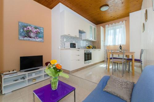a living room with a vase of flowers on a table at House Andelka in Supetar
