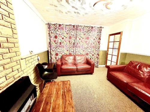 a living room with a couch and a table at Inviting 2-Bed House in Birmingham in Birmingham