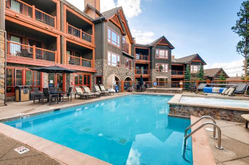 a swimming pool in front of a apartment building at BlueSky Breckenridge in Breckenridge