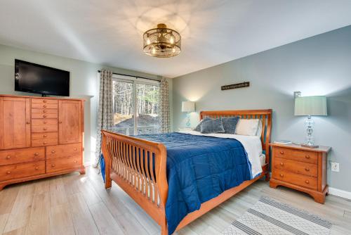 a bedroom with a bed and a dresser and a tv at Tranquil Ogunquit Condo Walk to Beach and Marina! in Ogunquit