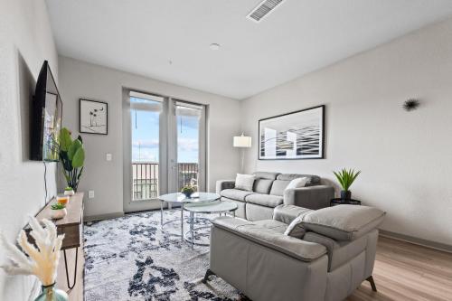 a living room with a couch and a table at Downtown St Pete 2 Bed Near Tropicana Field WIth Free Parking in St Petersburg