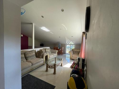 uma sala de estar com dois sofás e uma mesa em Marissa Guest House em San Ignacio