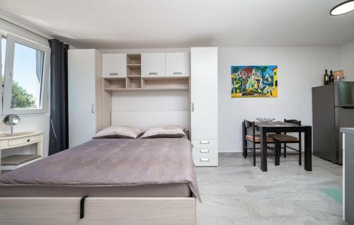 a bedroom with a bed and a desk and a table at House Peroj in Peroj