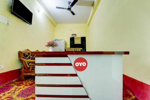 a staircase in a room with a ceiling fan at Hotel O Laxmi Marriage Hall Restaurant And Guest House in Islāmpur