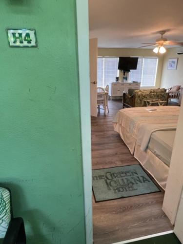 a room with a bedroom with a bed and a living room at The Green Iguana Hotel in Charlotte Amalie
