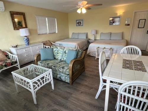 a living room with two beds and a couch at The Green Iguana Hotel in Charlotte Amalie