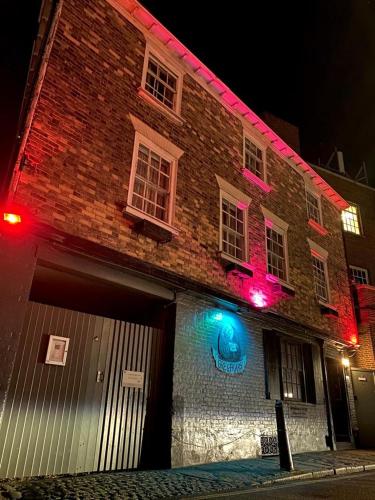 a brick building with red and blue lights on it at Greyfriars Lodge Canterbury in Canterbury